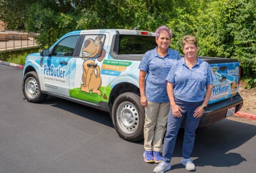 Rosemarie Richardson, owner of Pet Butler Chads Ford, stands next to a Pet Butler truck.