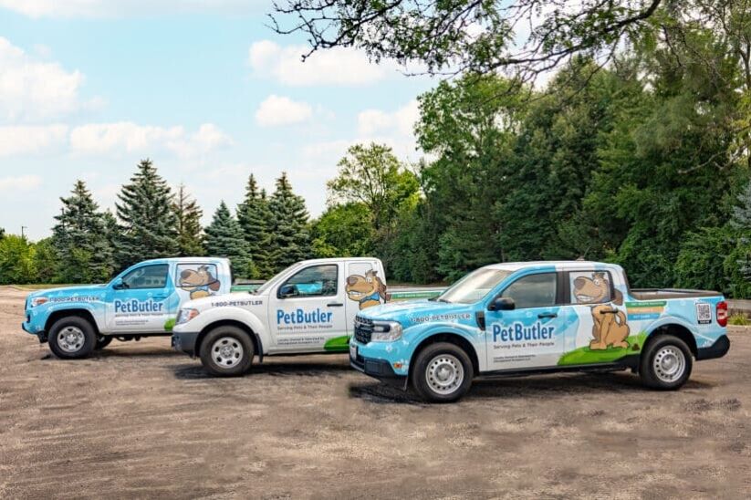 3 Pet Butler Trucks with custom vehicle wraps of a smiling dog