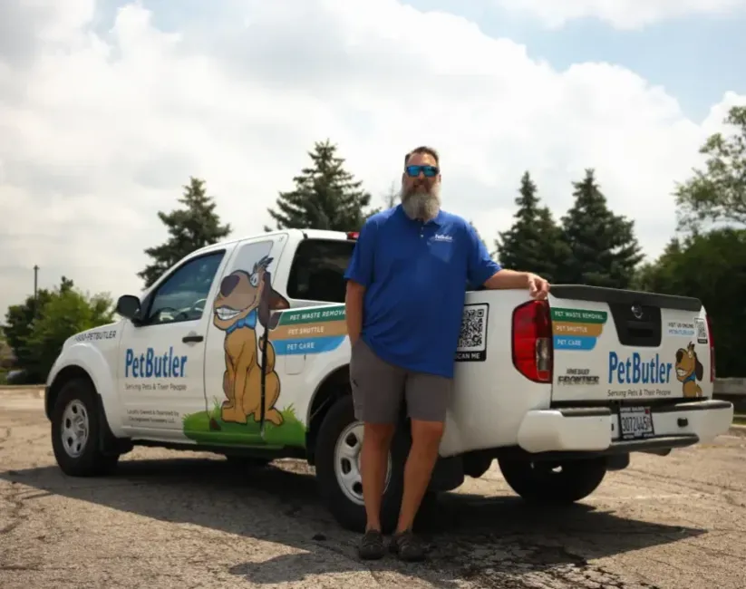 Scott Cockrell, owner of Pet Butler of Huntsville, AL, standing next to a Pet Butler truck.